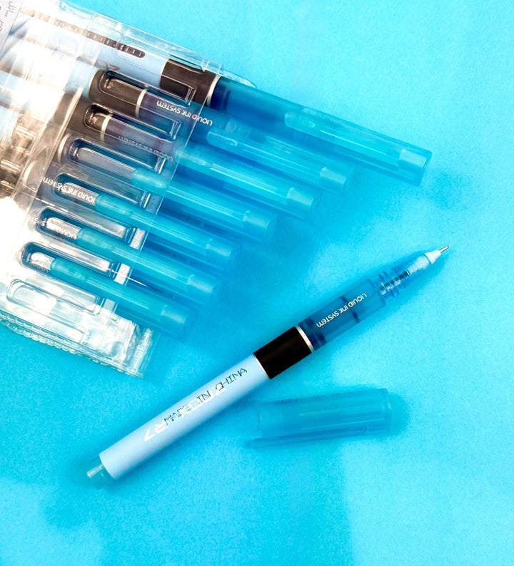Set of blue pens with clear plastic cases on a blue background