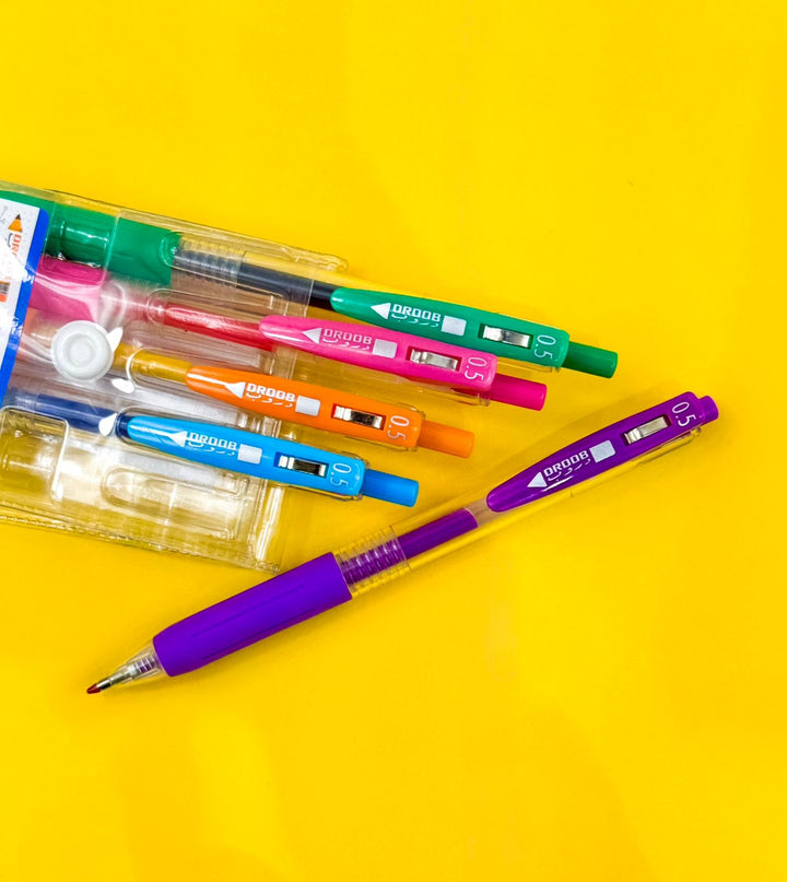 Colorful pens and markers on a yellow background