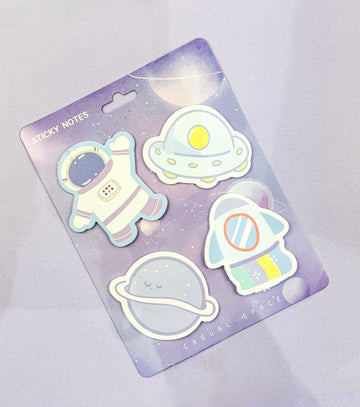 Pack of sticky notes with space-themed designs on a light purple background