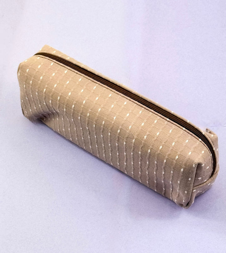 Beige fabric pencil case with a zipper on a light gray background