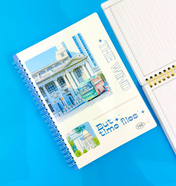 Notebook with scenic cover on a blue background